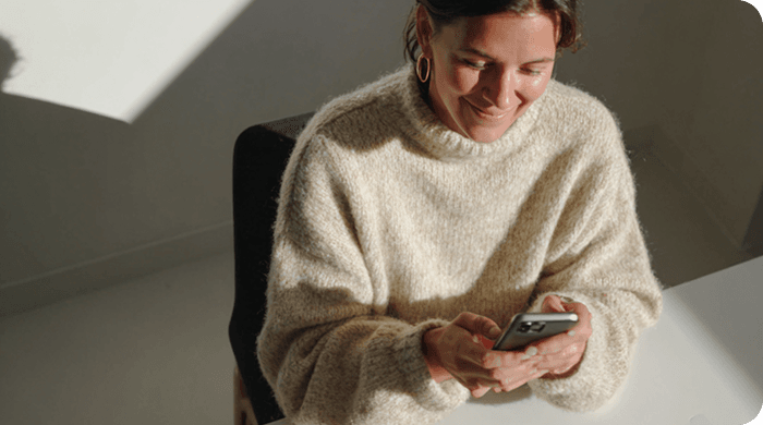 Woman working at desk with phone